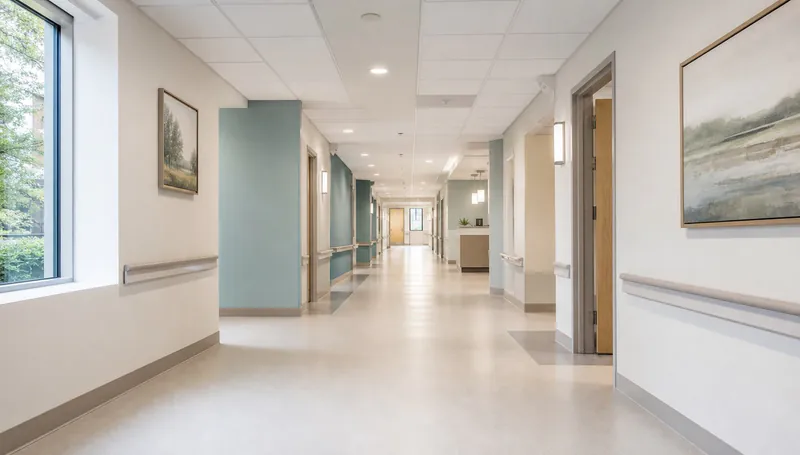 Illustrative healthcare corridor with handrails and a clear passage.